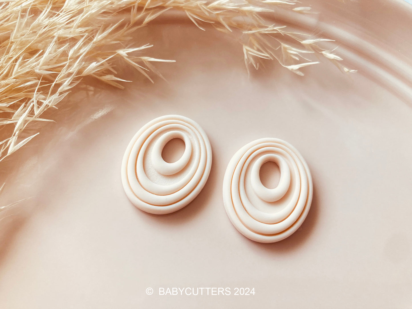 Embossed Abstract Oval Twirl Shape with Oval Hole Polymer Clay Jewellery Cutter